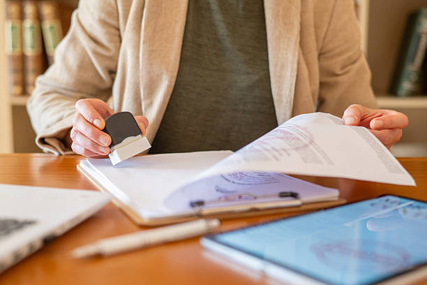 Hands stamping an official document