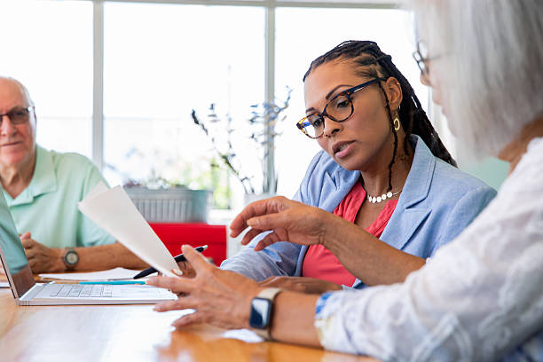 Notary reviewing a contract with senior clients